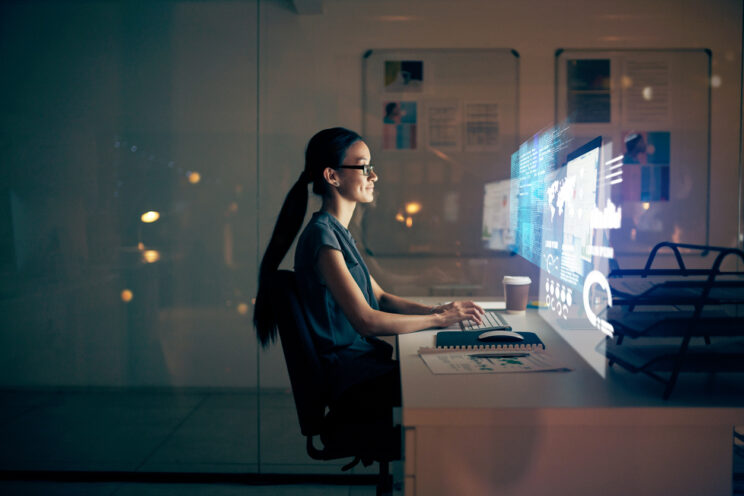 Shot of a young programmer using a computer in a modern office